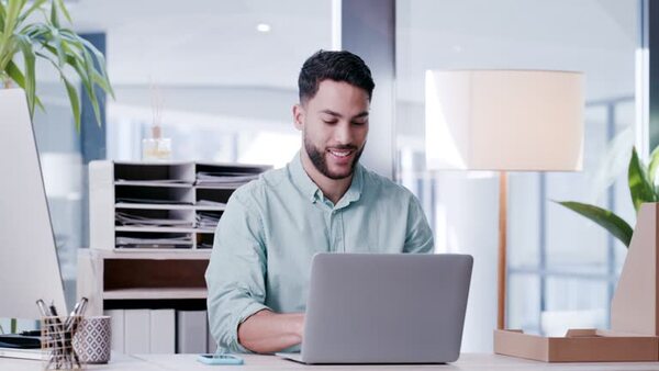 Person taking a short pause in a bright office with a laptop on the desk
